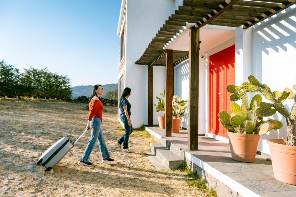 Guests arriving at a short-term rental with luggage