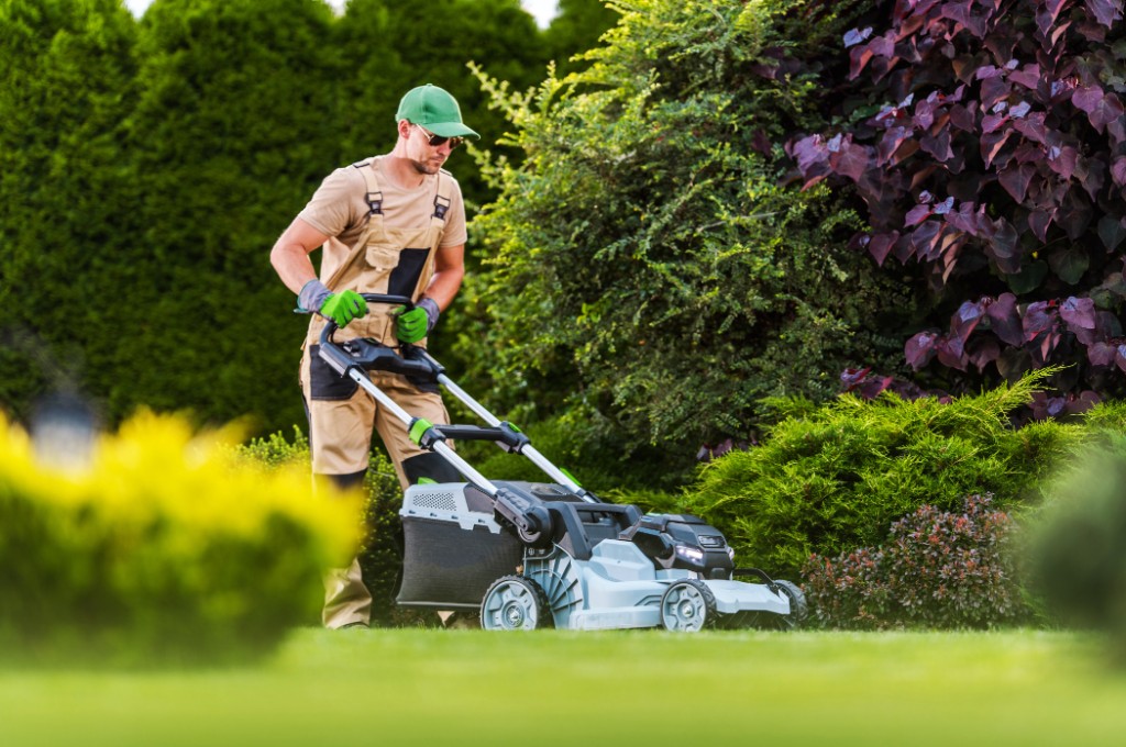 Landscaper mowing a property lawn